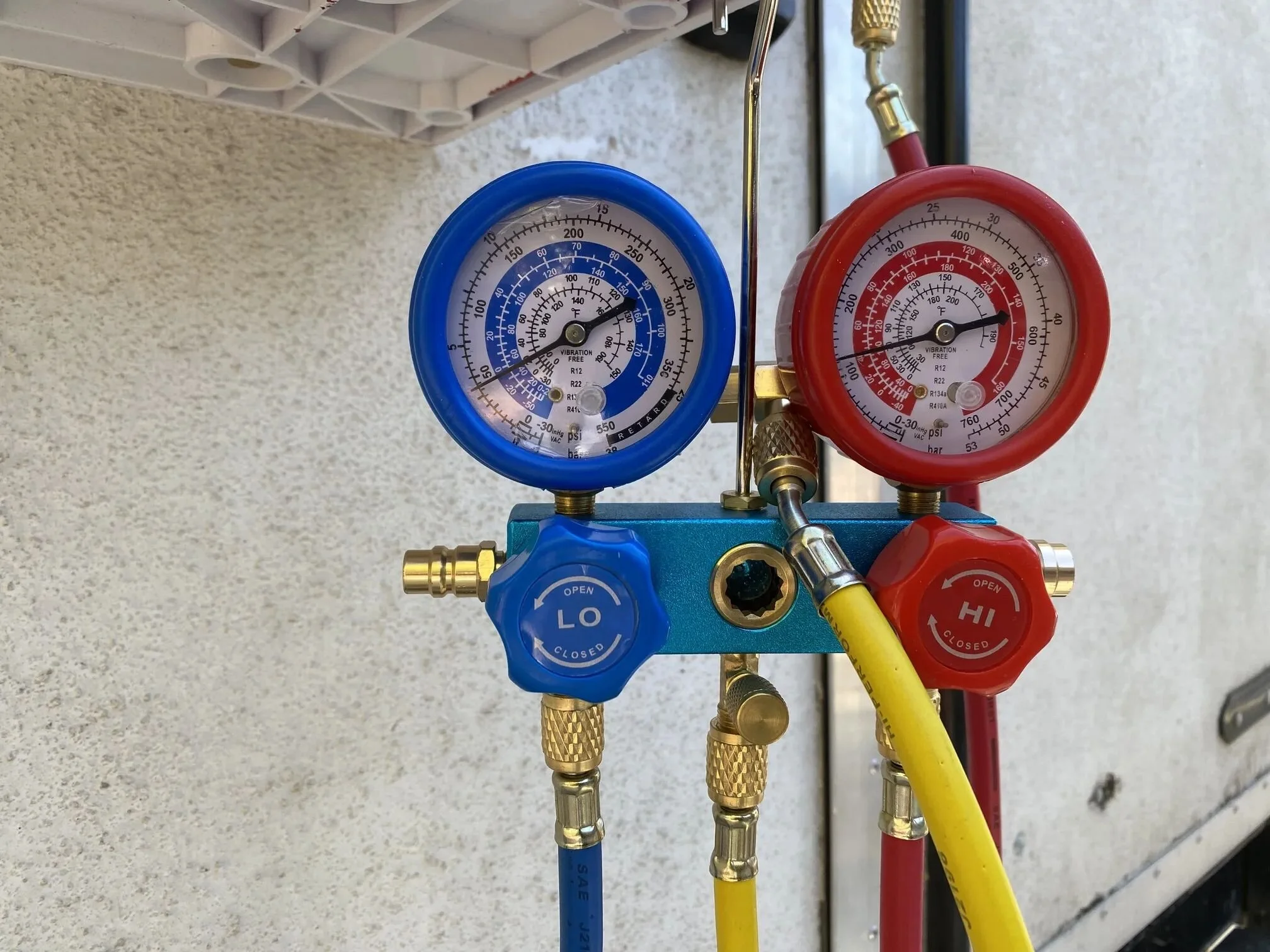 Drawing vacuum and adding refrigerant