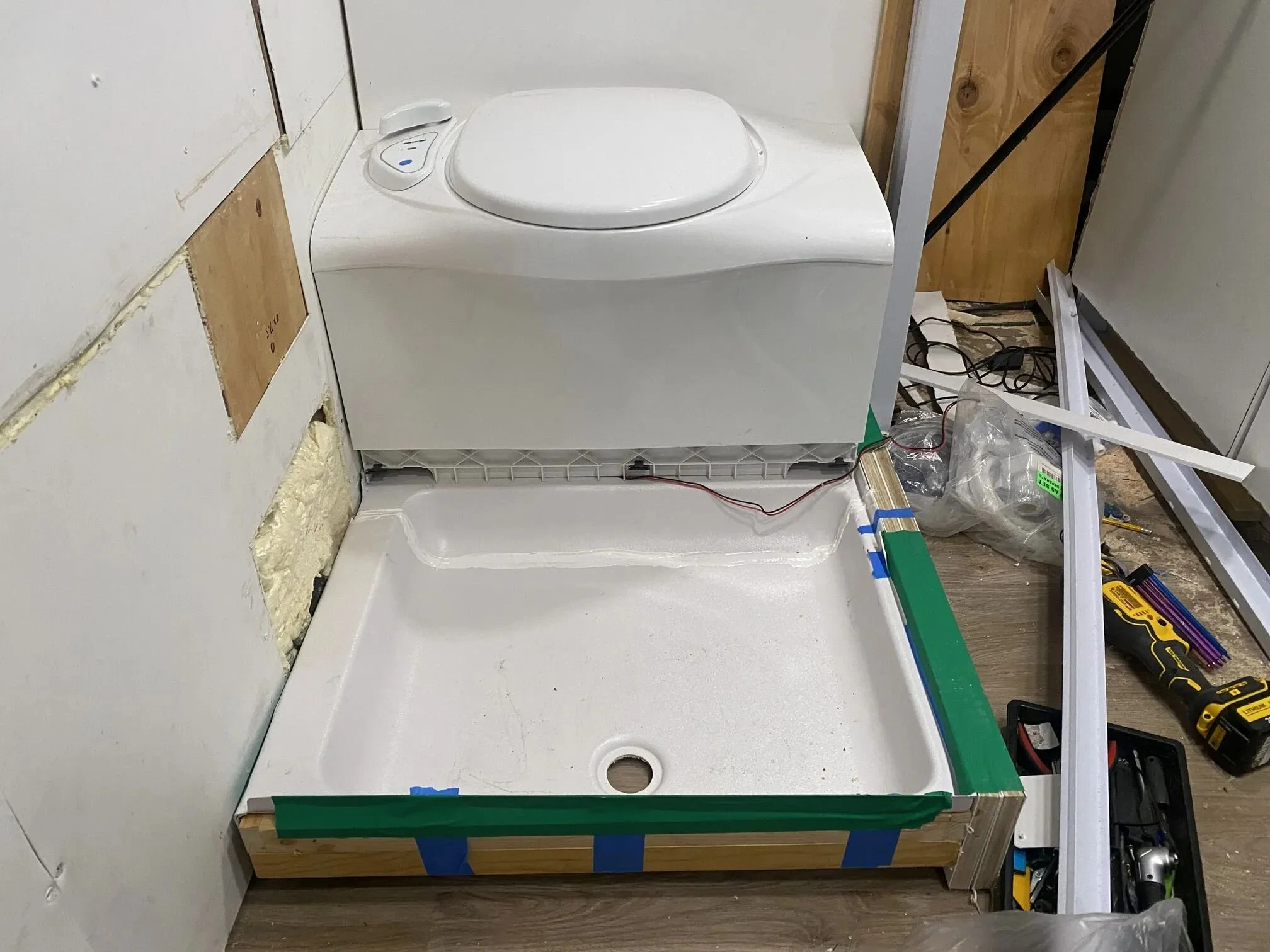 Shower pan re-sized, base built, and mounted the flushing cassette toilet