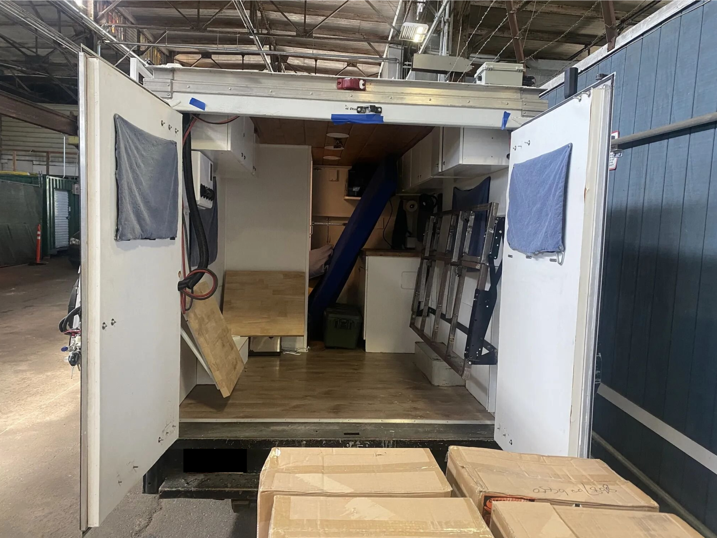 Cargo mode. Rear fully tucked, with couch/bed folds flat against the wall