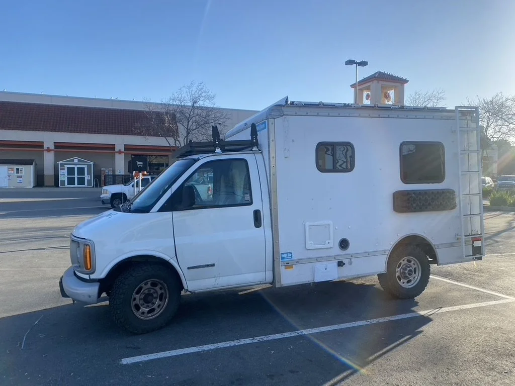 RV windows, bailout board, roof ladder, external shower, pull-out toilet tank, and charging port